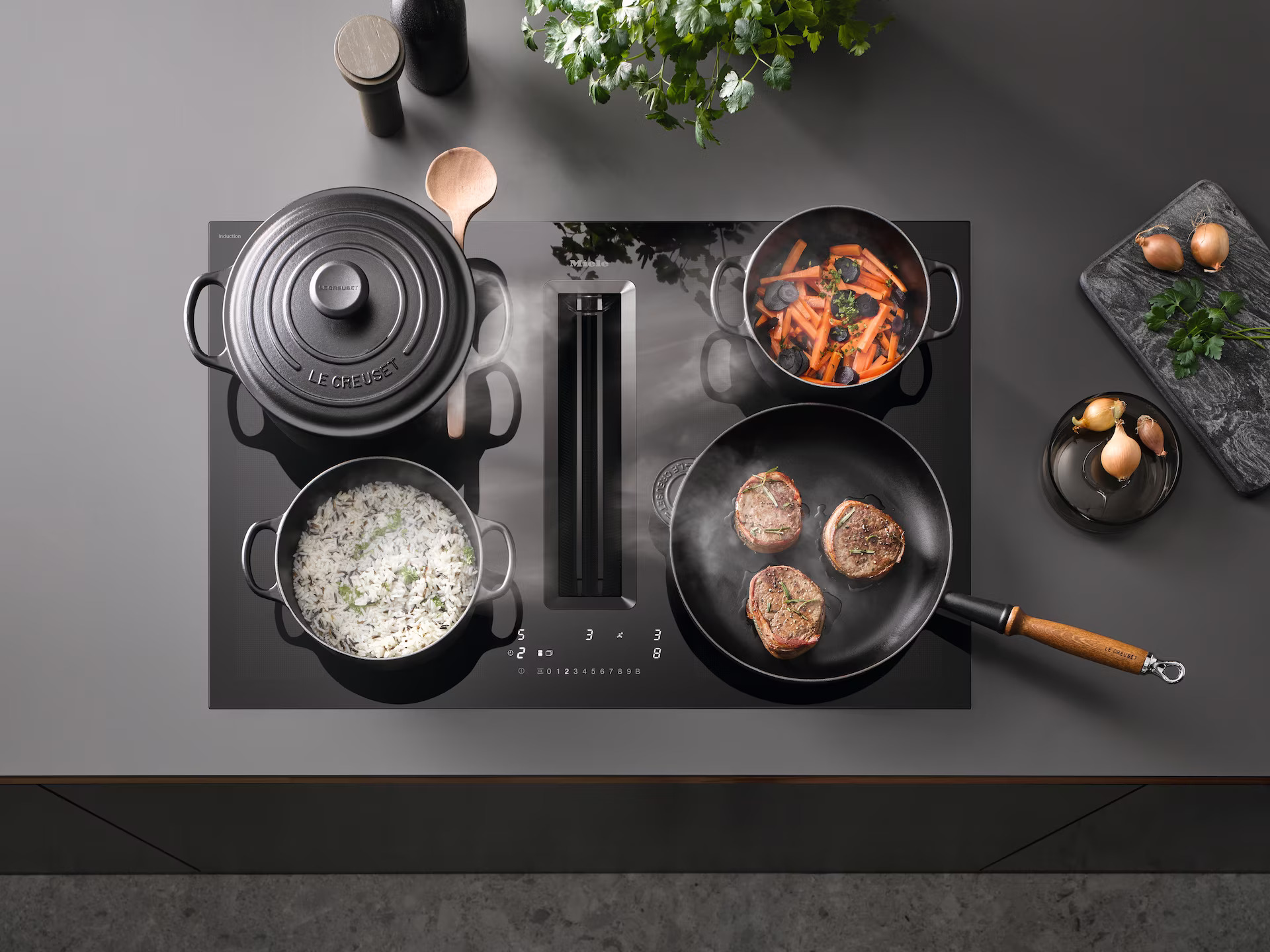 Miele Induction Hob with Integrated Extractor and Pans on Top