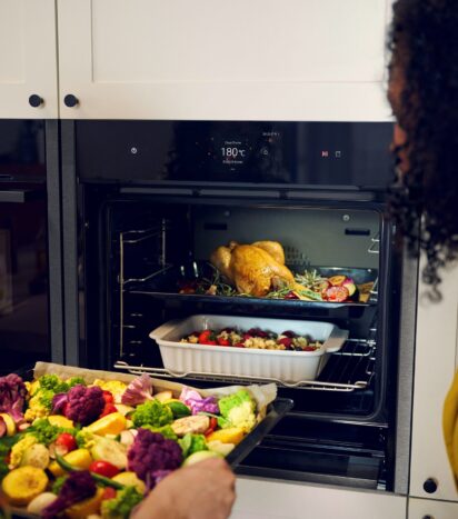 Women Putting Food In Combination Oven with Microwave