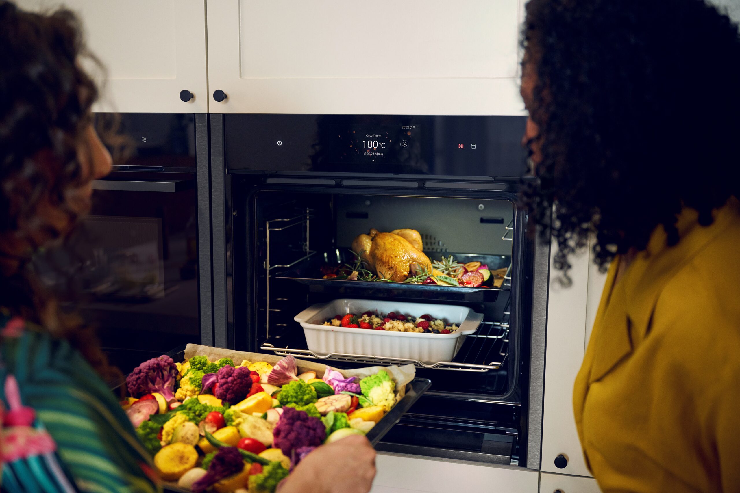 Women Putting Food In Combination Oven with Microwave